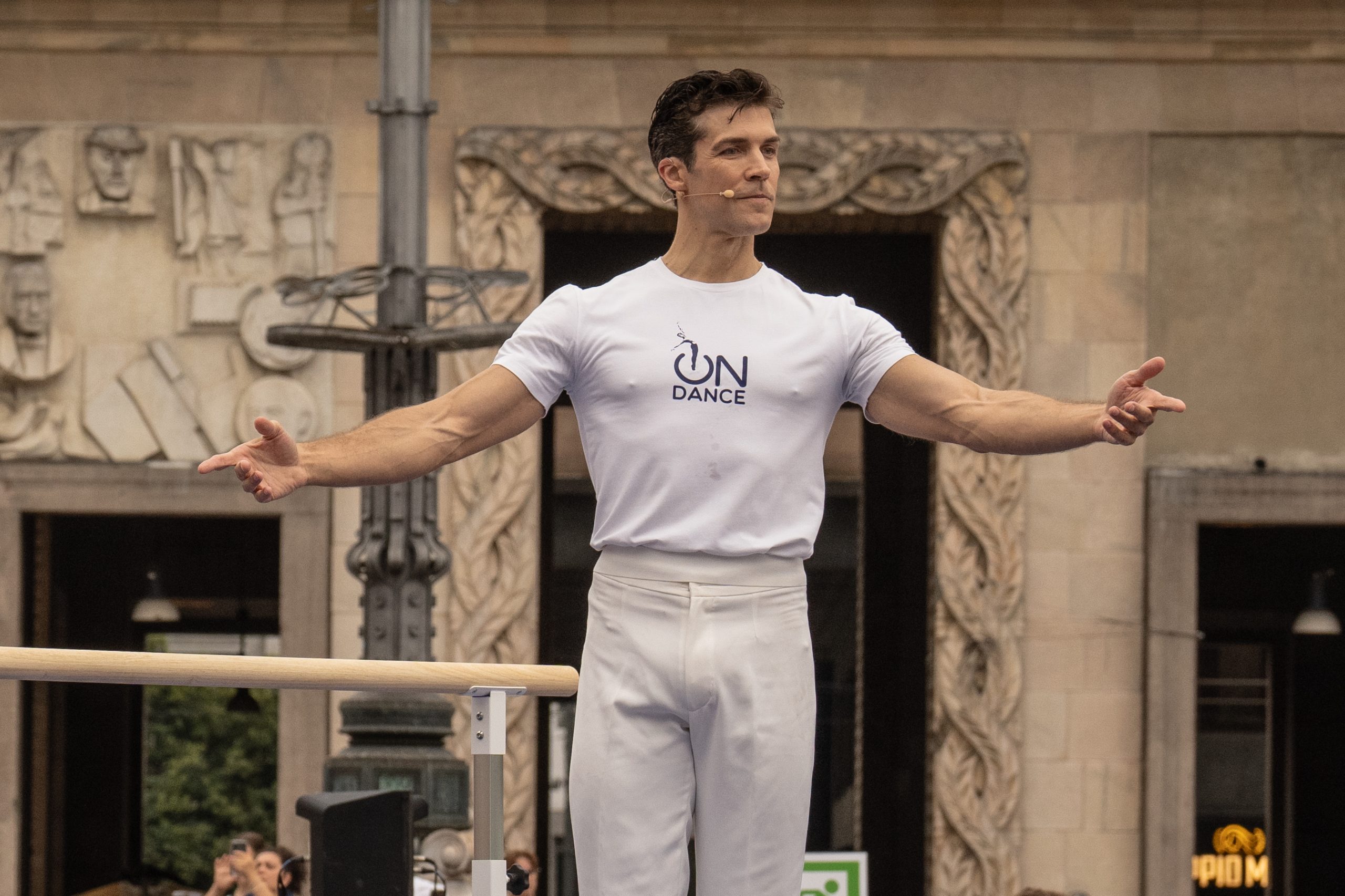 roberto bolle vestito di bianco con microfono